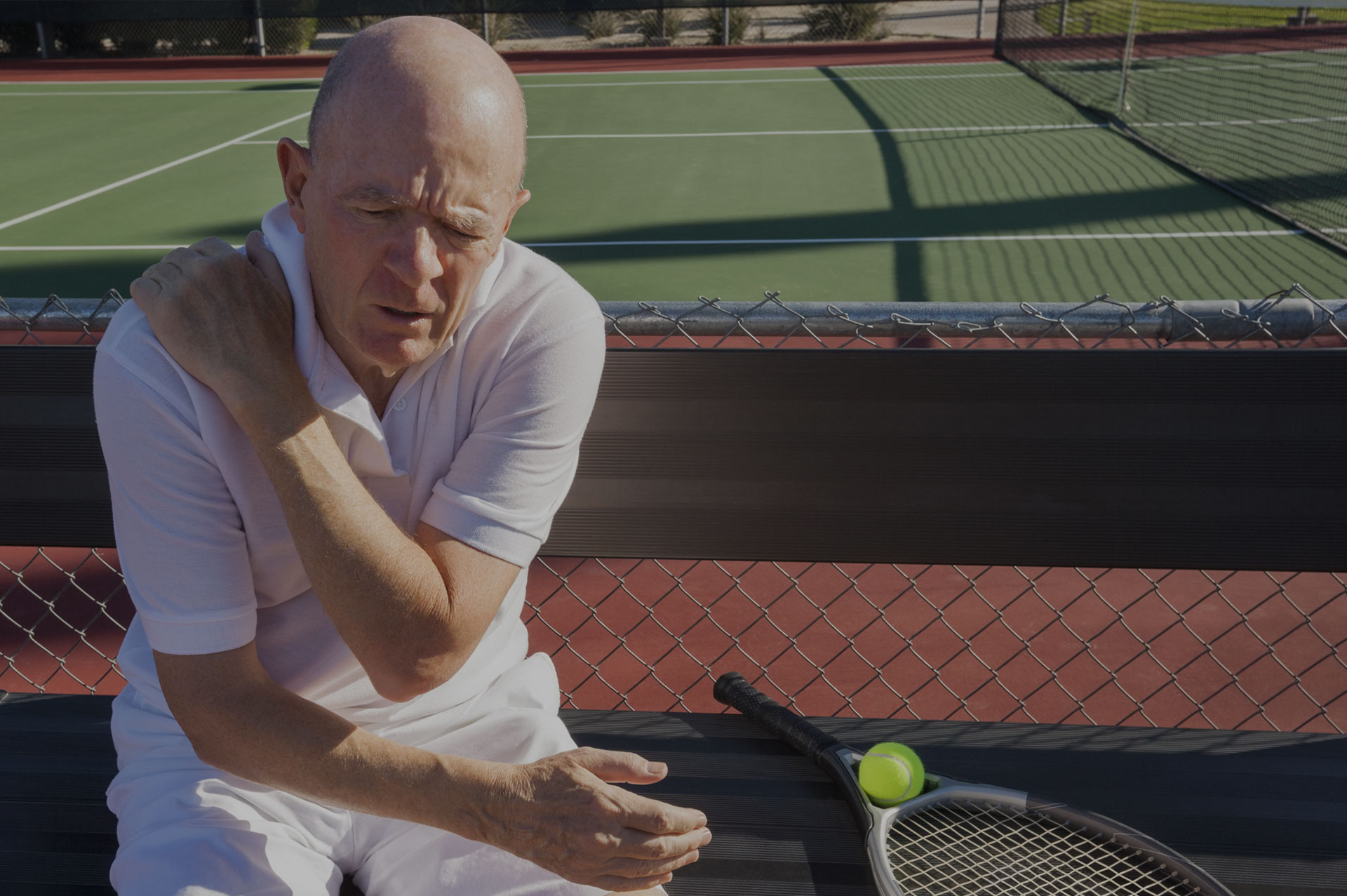 Future Search Trials Fibromyalgia Study FSTrials Man sitting in pain holding arm joint pain at tennis court